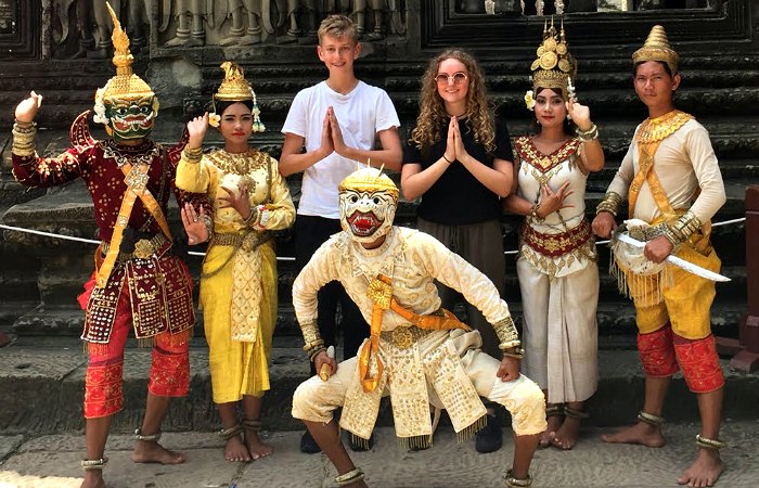 Cambodia family holiday - brother and sister posing with dance troop