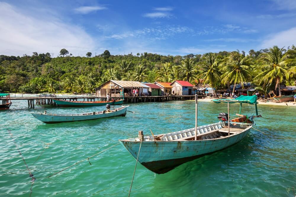 Boats floating on the clear waters of Kep beach in Cambodia
