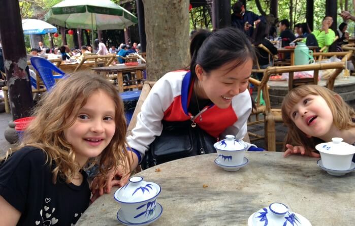 China family holidays - two young tourists laugh with their guide