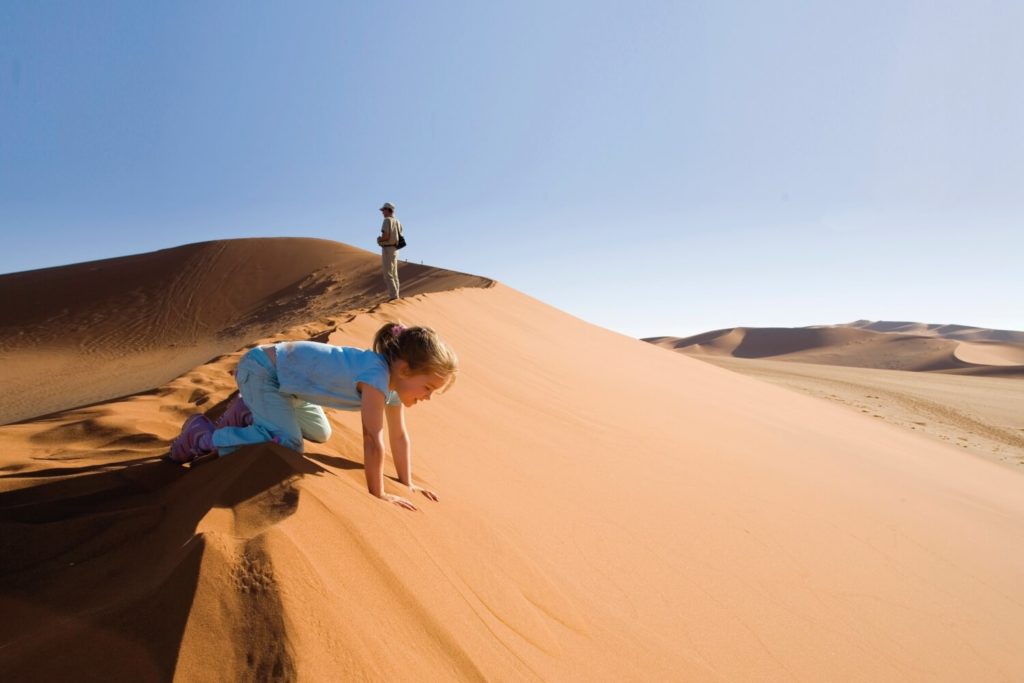 Namibia family holidays - climbing the dunes at Sossusvlei