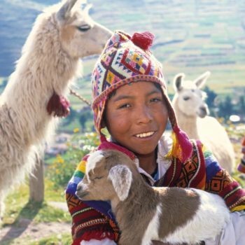 Peru family holidays - young shepherd with a baby goat