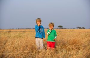 Serengeti smile - two boys having fun on a Tanzania family safari