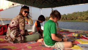 Where to stay in Egypt - family sitting on comfortable Felucca deck