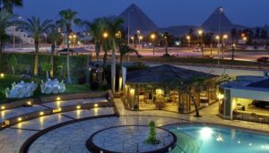 Where to stay in Egypt - Mercure le Sphinx photo showing pool with pyramids in distance