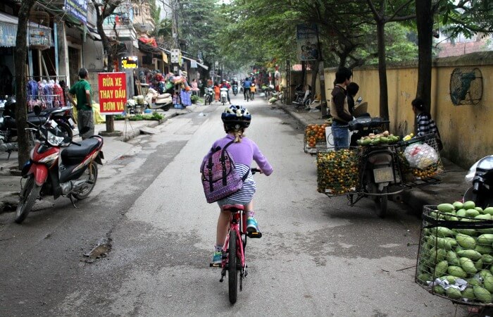 Family bike ride abroad - cycling in the back streets of Hanoi
