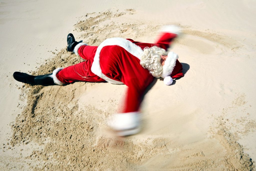 Family holidays at Christmas - carefree Father Christmas on the beach