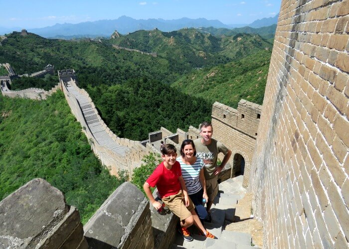 Long haul family holiday - a family standing on the Great Wall of China