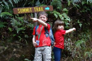 Climbing Mount Kinabalu with kids - two youngsters by the summit trail sign