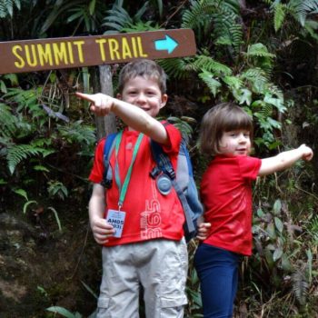 Climbing Mount Kinabalu with kids - two youngsters by the summit trail sign