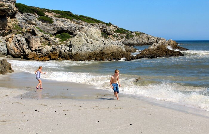 Kids playing on the beach at Walkers Bay South Africa