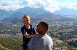 Father and son looking over a sensational South African landscape on a family holiday