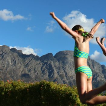 best budget family holidays photo of kids jumping into a swimming pool in South Africa