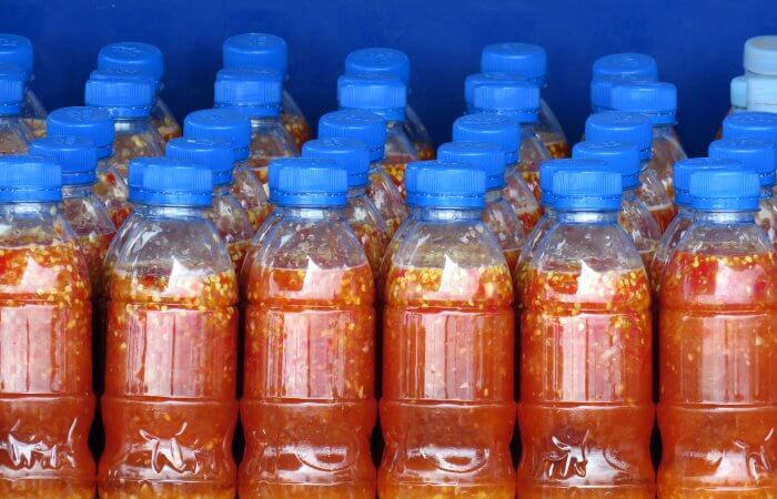 Cambodia photos - brightly coloured chilli sauce bottles