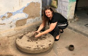 Charlotte trying out pot making on a village tour