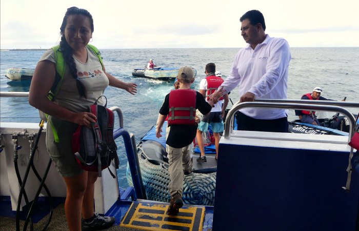 Stepping on to the panga on Galapagos Island cruise
