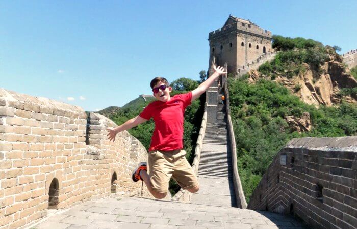 China with kids - Boy jumping in air on Great Wall of China