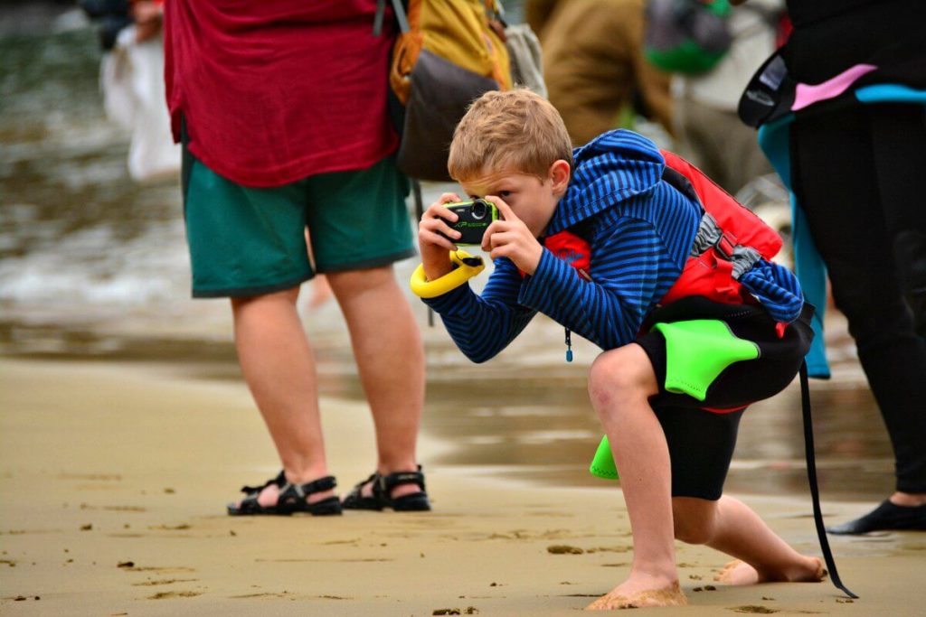 Galapagos family trip - boy photographing tame wildlife