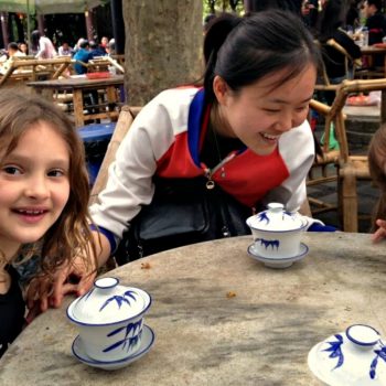 Two young girls taking afternoon tea on a China with kids itinerary