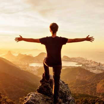 Family holidays in Brazil - teenager overlooking the classic view of Rio at sunset