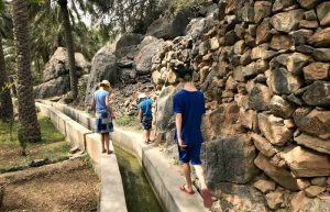 Oman for kids itinerary - children exploring Misfah Oasis