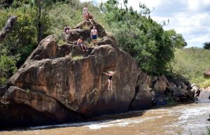 Kids playing in river Laikipia holiday