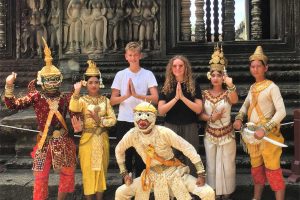Cambodia with kids - group of young visitors and dancers at a temple