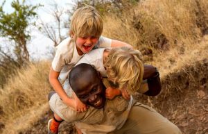Solo and single parent holidays in Tanzania - kids playing with the guide