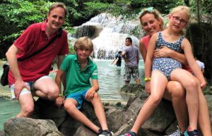 Thailand with kids itinerary - family in front of waterfall