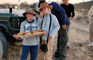 Kids with snacks on safari in Etosha - places to visit in Namibia