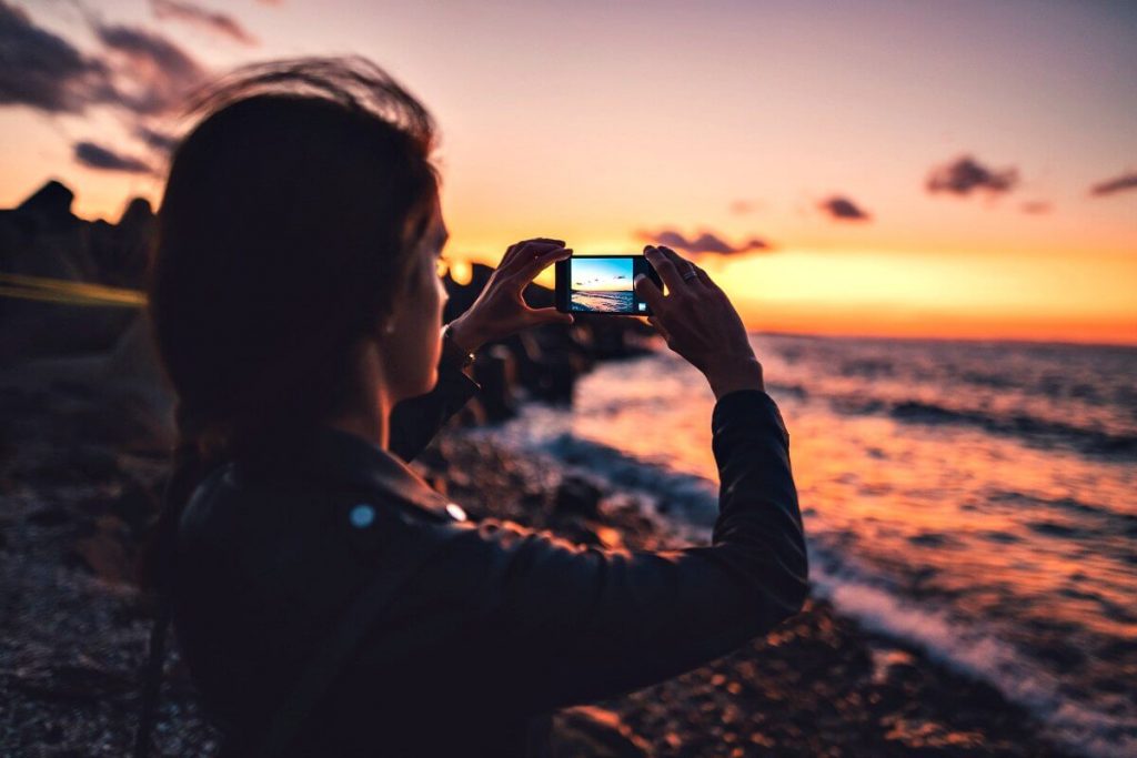 Young photographers awards 2018 - young woman on beach taking a photograph