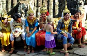 Cambodia with kids holiday, young girl meets dancers at Angkor Wat