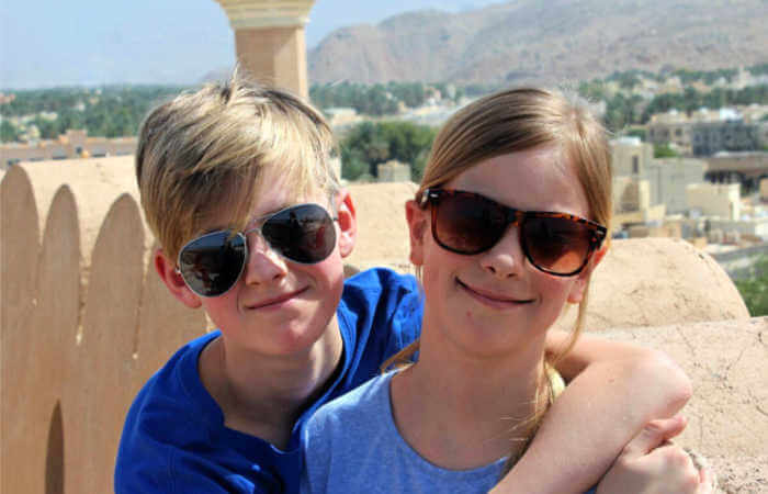 Family exploring the fort at Nizwa on an Oman holiday itinerary