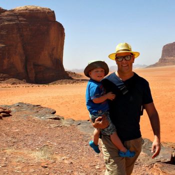 Toddler-friendly holidays - close up of father and young son in Wadi Rum desert in Jordan