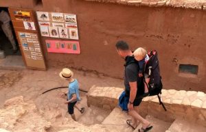 Family using a child back pack when travelling with toddlers in Morocco