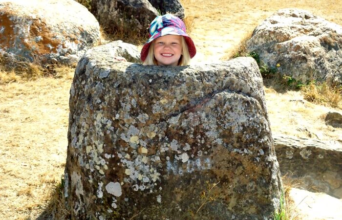Young child playing on the Plain of Jars in Laos