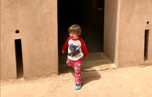 Toddler friendly holidays - child exploring a fort in Oman