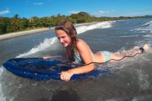 Best family beaches - child body boarding in Costa Rica