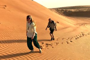 Father and daughter walking in the dunes - Wahiba Sands