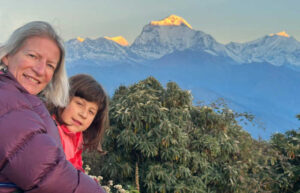 Family hiking in Nepal watching dawn over the Annapurna Mountains