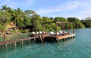 The lake at Rancho Encantado with loungers - where to stay in Mexico