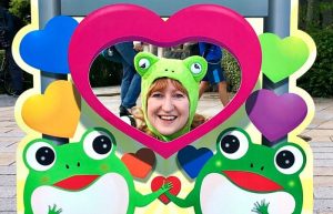 Kelly posing in a frog costume - example of quirky Japanese humour