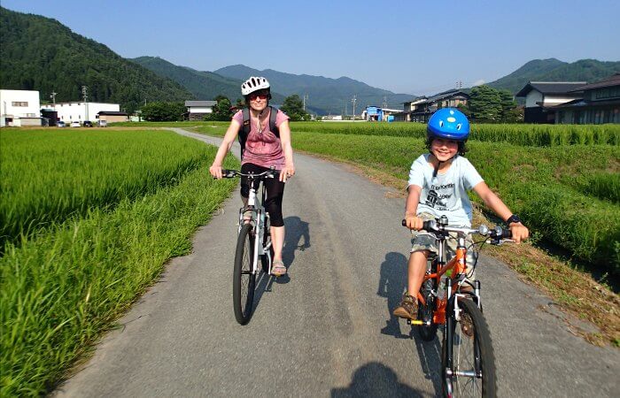 Parent and child cycling in the Japanese Alps