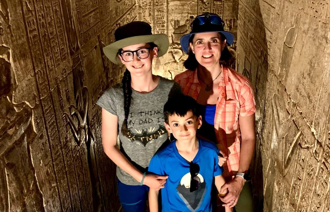 Mother with children inside tomb on an Egypt family adventure holiday