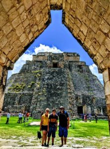 Family posing in front of Mayan ruin in Mexico