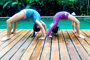 Family Travel 2020 - two children doing acrobatics by pool in Costa Rica