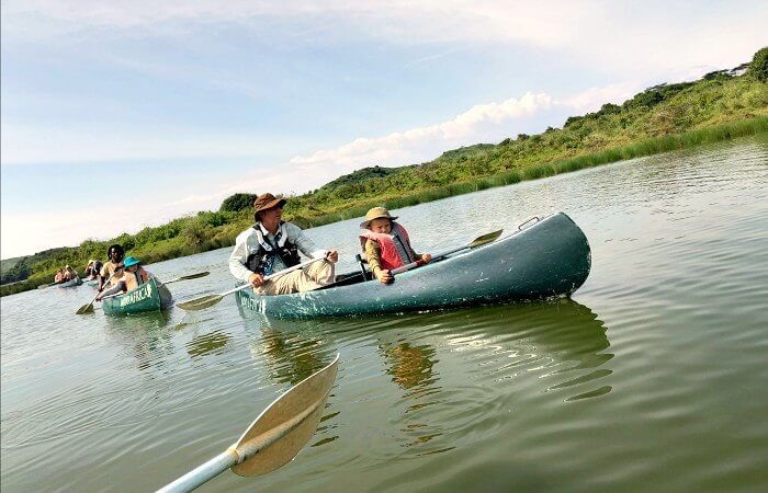 Family canoeing in Arusha Park on Tanzania with kids itinerary