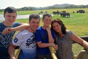 Family portrait of kids on safari with elephants in the background - Sri Lanka with kids holiday