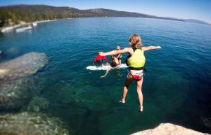 Swimming in Lake Tahoe with child jumping in, on a US family road trip