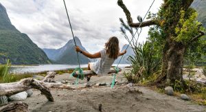Milford Sound - girl on home-made swing
