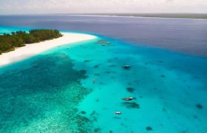 Aerial of Mnemba Island where families can snorkel and dive on a Zanzibar with kids holiday